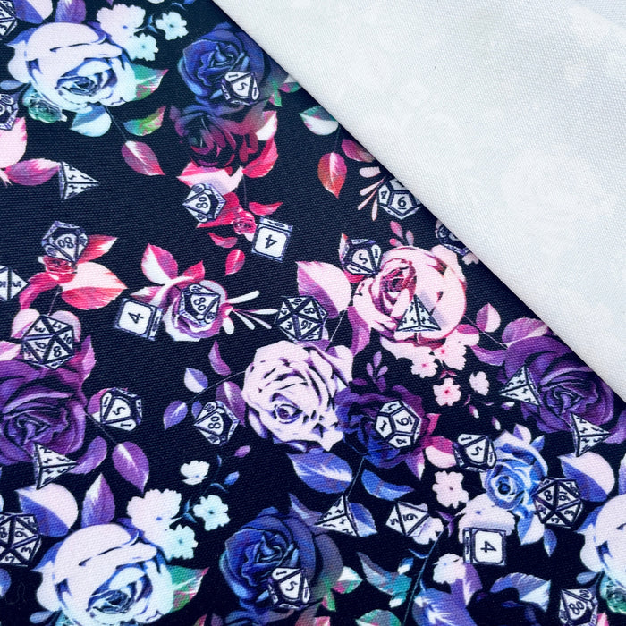 This printed WPCotton features a design with roses in a blue to pink to green ombre and different types of dice on top.