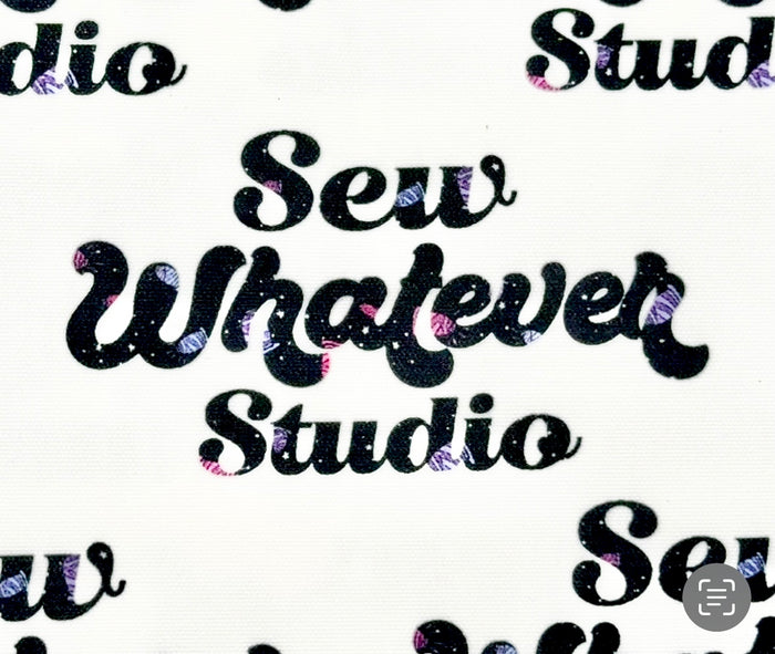 This printed WPCotton features the "Sew Whatever Studio" logo in black with multicolored spools of thread in the wording on a white background.