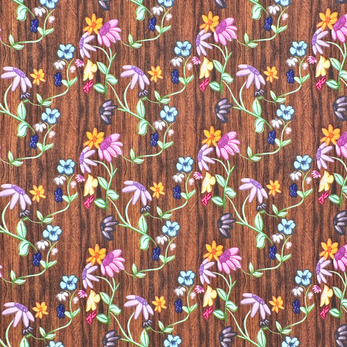 This printed WPCotton consists of different colorful flowers on a wood-esque background.