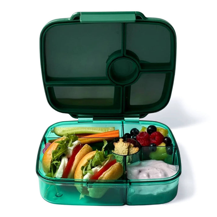 Green plastic leakproof bento box with 5 compartments, lid open, front view, filled with food items, on a white background.
