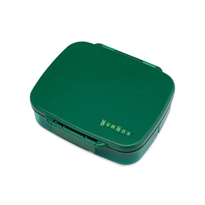 Green plastic leakproof bento box, lid closed, overhead angle view, on a white background.